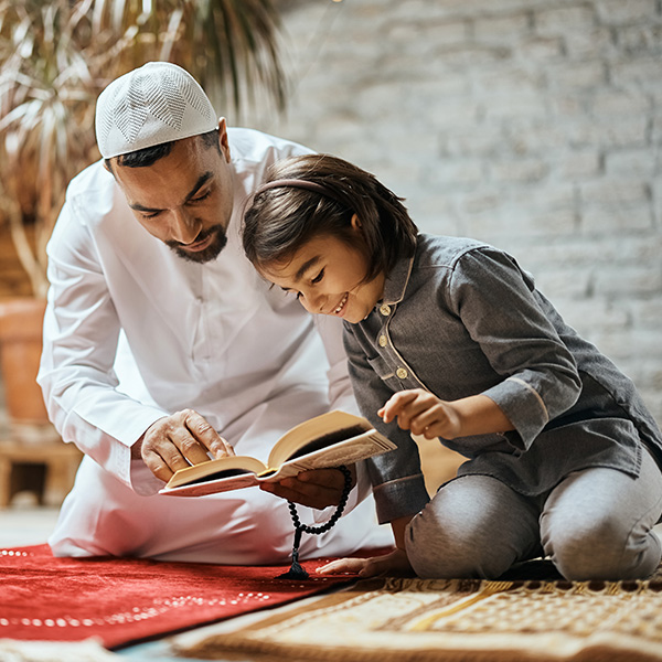 Father and daughter learning Quran